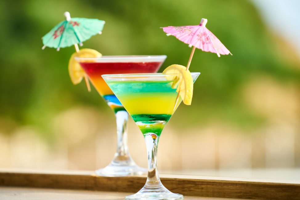martini glasses with lemon and umbrella tropical drink